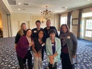 7 women standing together