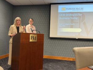 2 females behind a lectern